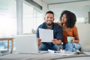 Happy Couple Paying Bills