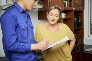 Technician Explaining Paperwork To Client